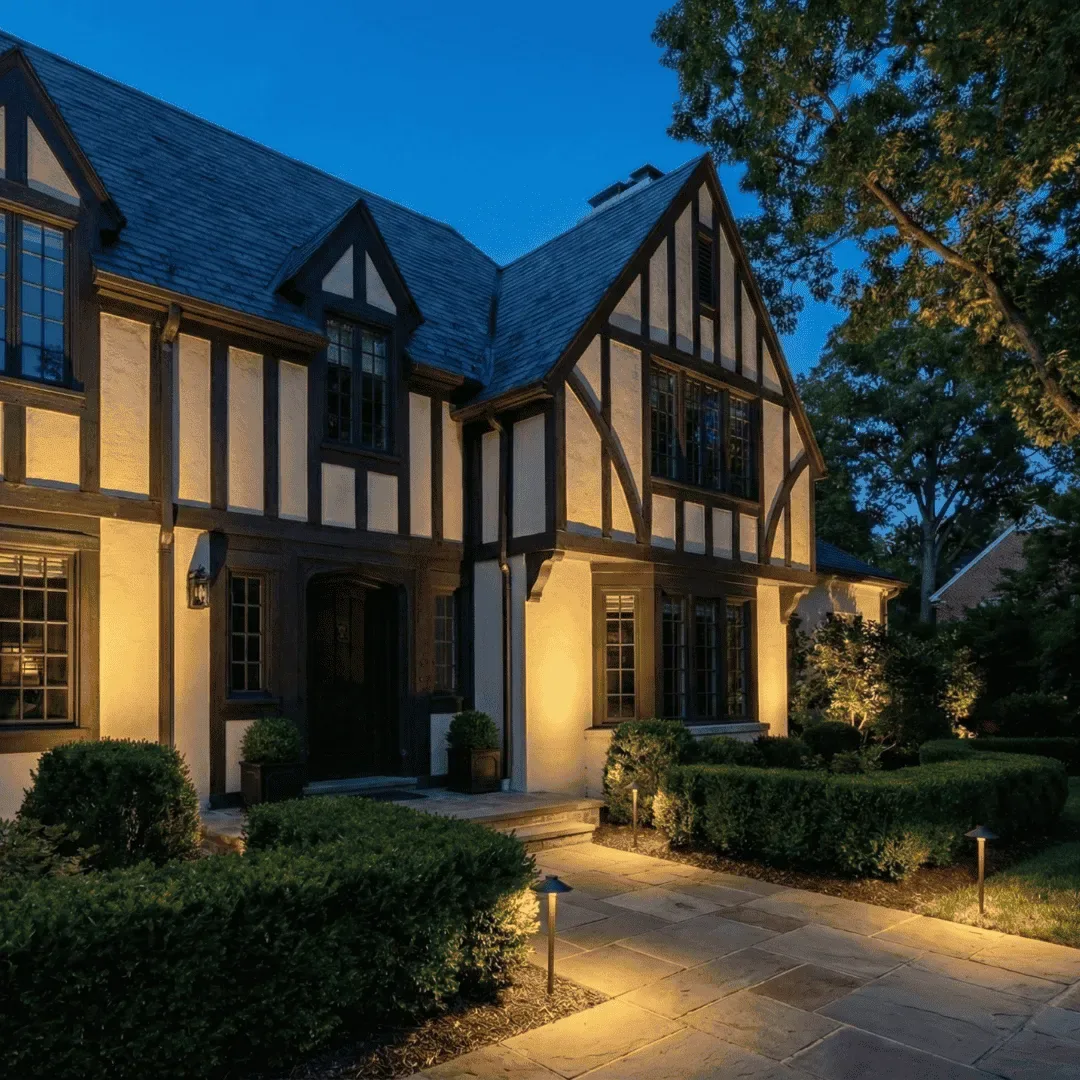 Warm landscape lighting illuminating a home and its garden at night