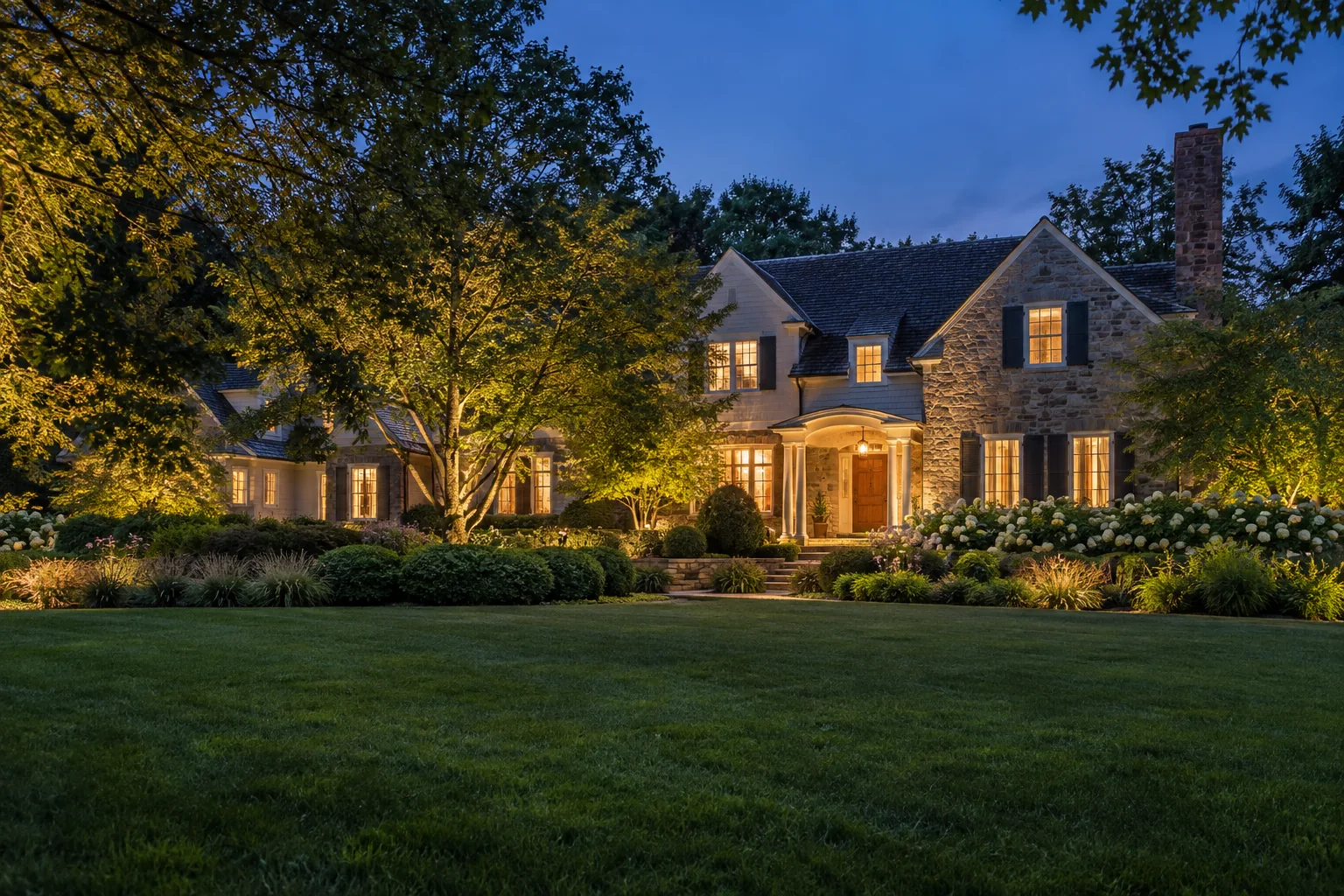Established home and mature garden with balanced warm lighting and deep natural shadows